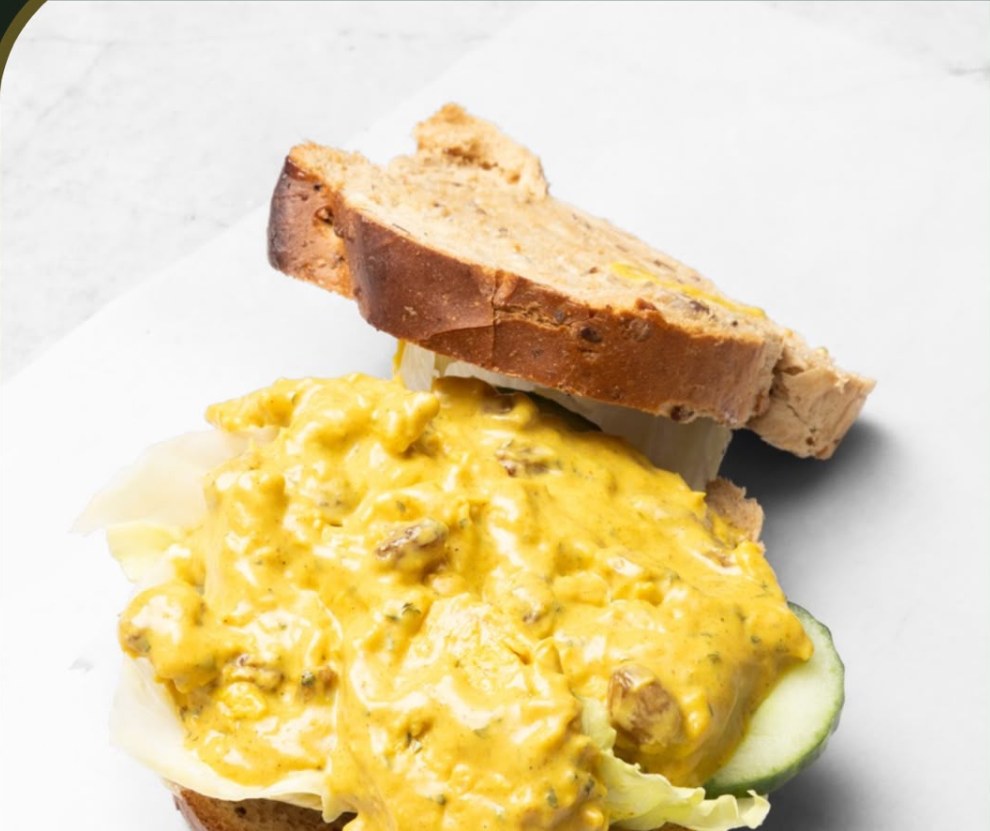 Coronation chicken piled on granary bread with lettuce and cucumber